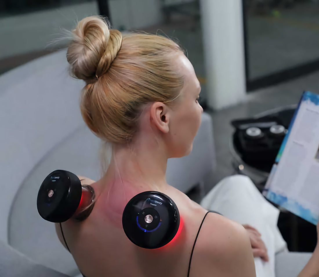 lady with 2 electric cupping machines on her back