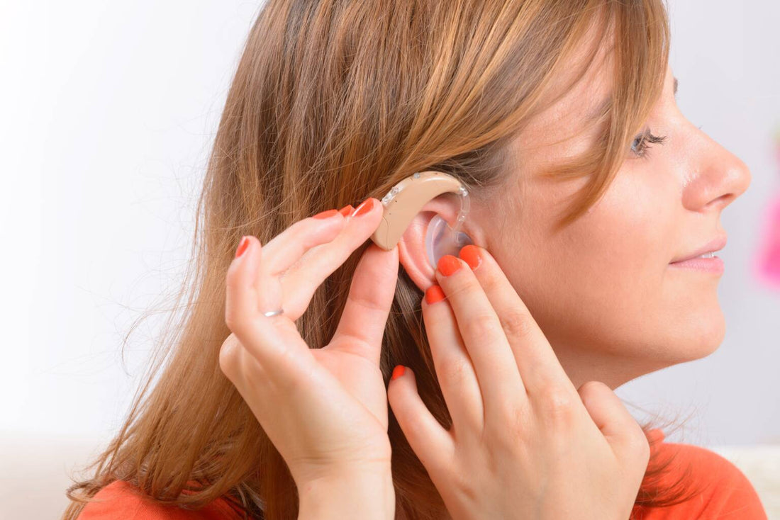 Young lady fitting a hearing aid